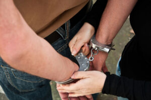 Police Officer Puts Handcuffs — Fayetteville, NC — Britt Carl L Jr